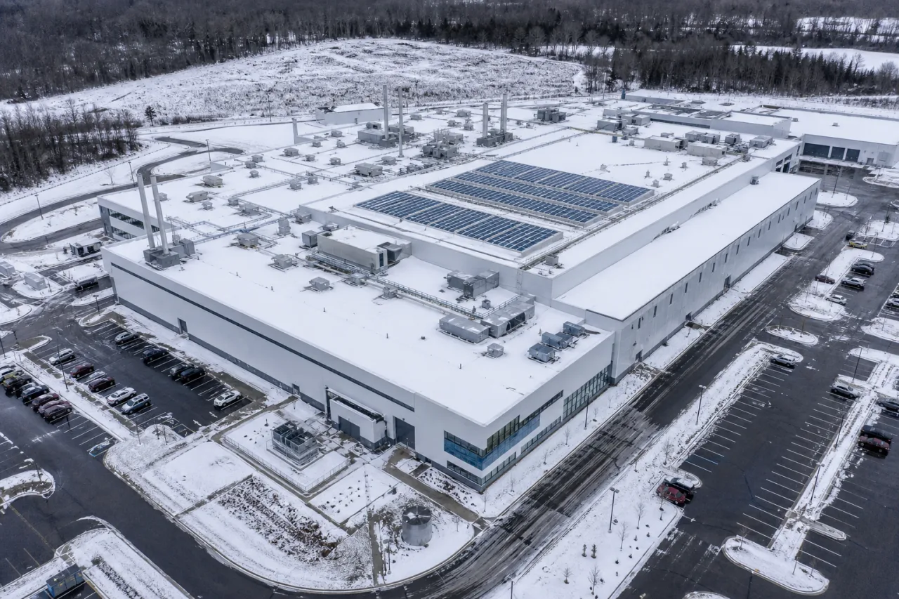 Aerial view of a pharmaceutical production building with a snow-covered flat roof